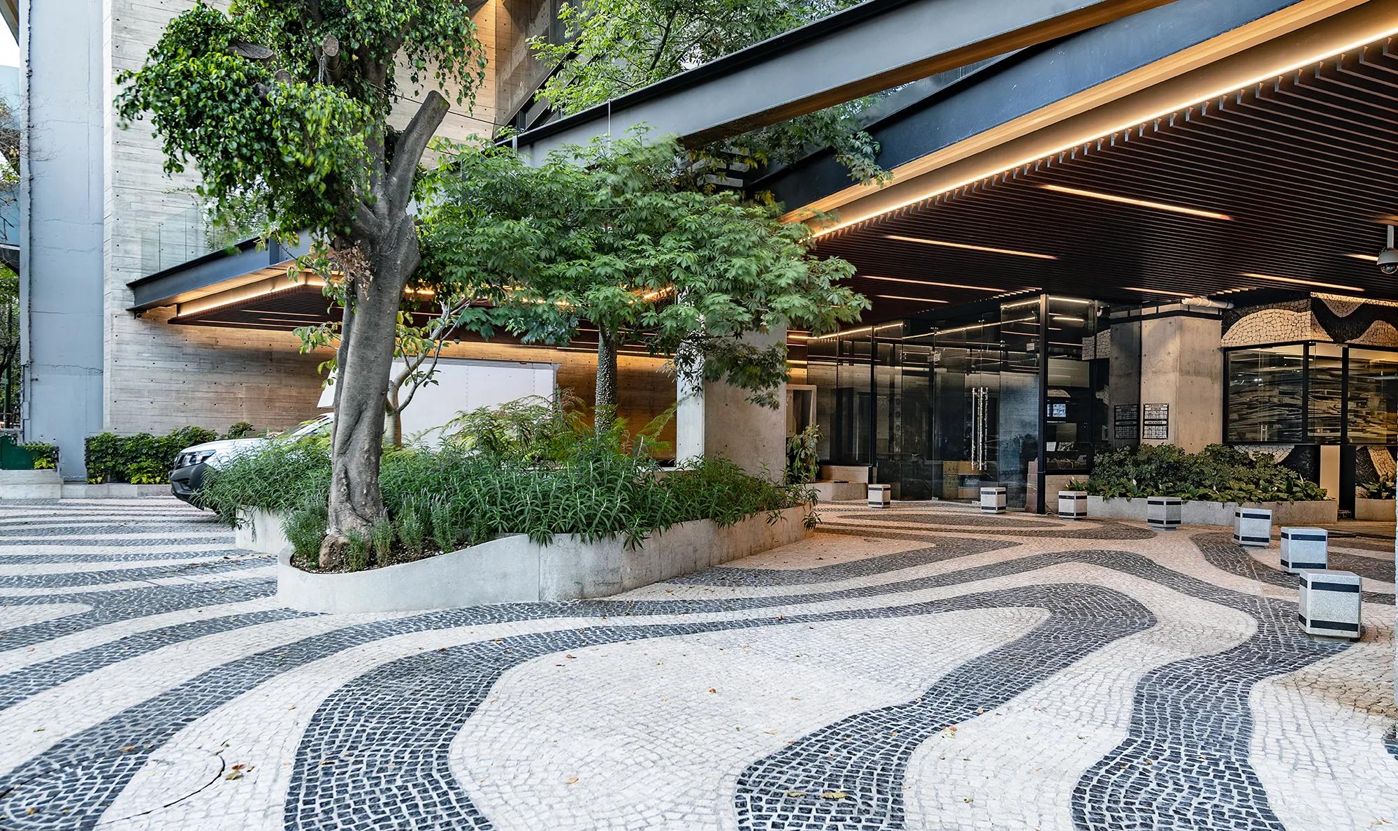 Exterior of office building with lots of greenery.